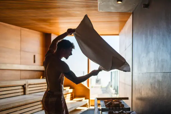 Een man houdt een handdoek vast.