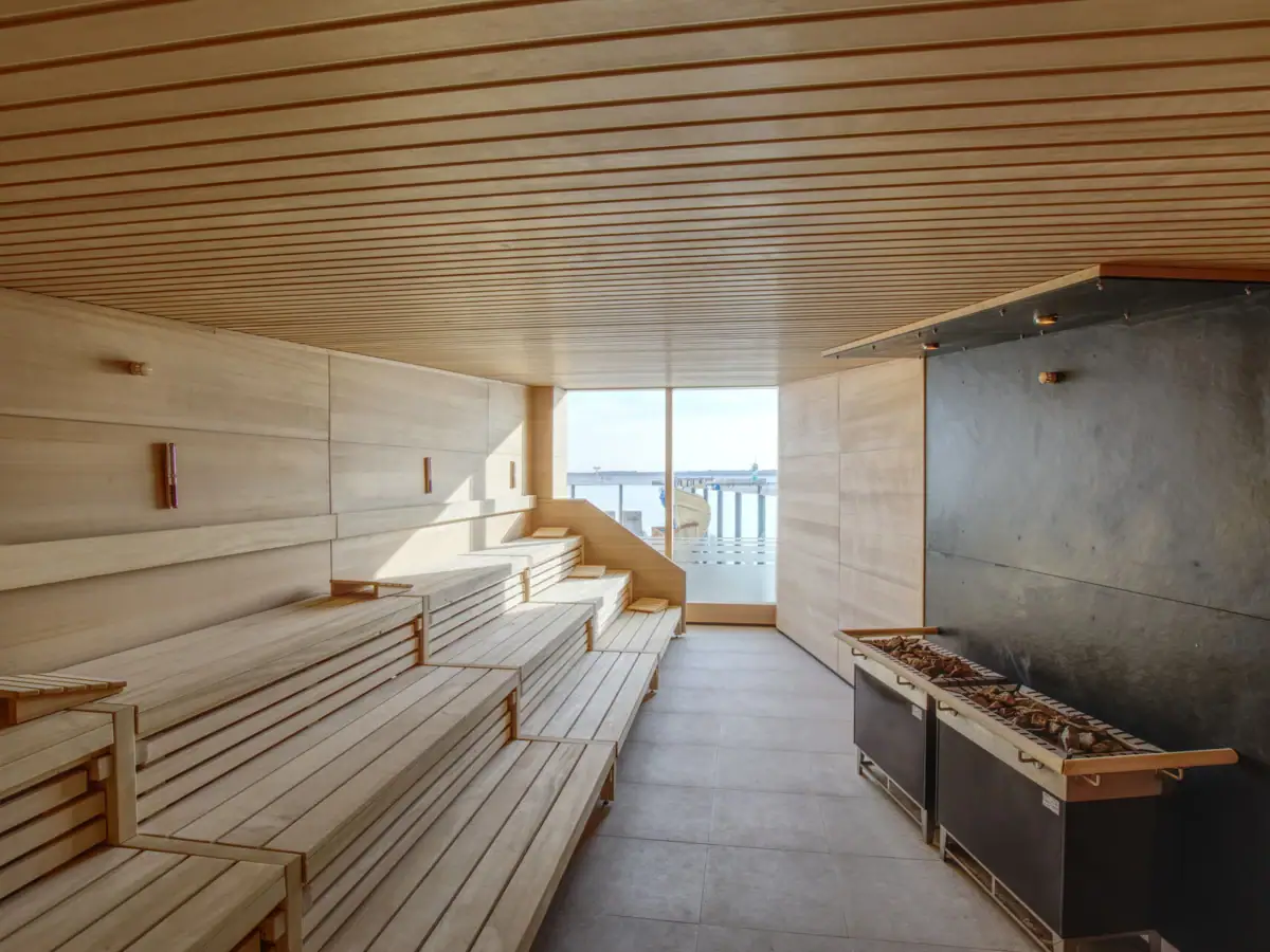 Een kamer met houten banken en een open haard.