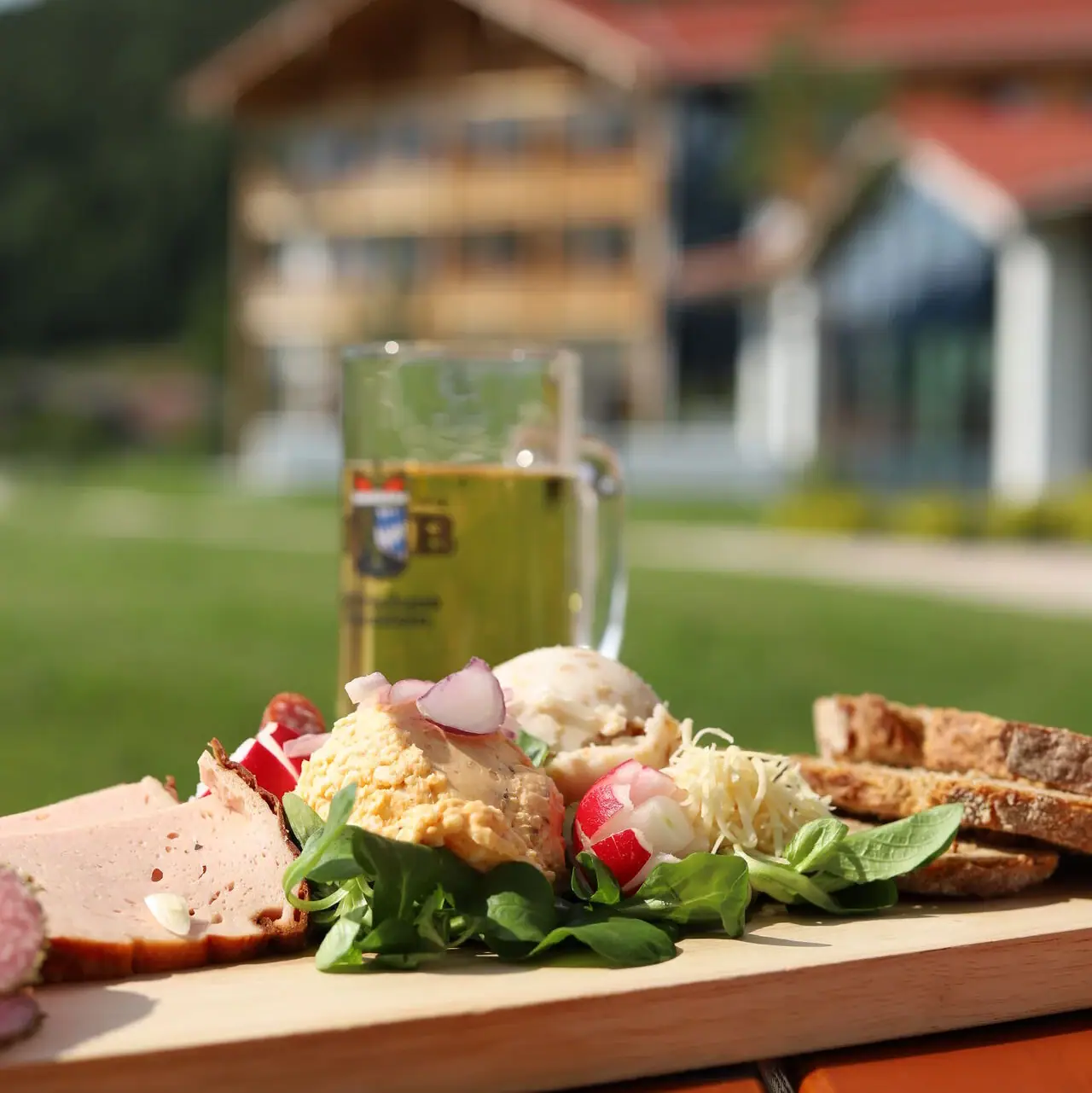 Snack Een bord eten en een glas bier op een houten tafel buiten.