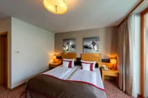 Suite Een bed met twee kussens en een lamp aan de zijkant.