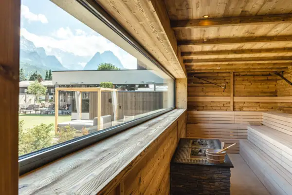 Sauna Eine Sauna mit einem großen Fenster und Blick auf die Berge.