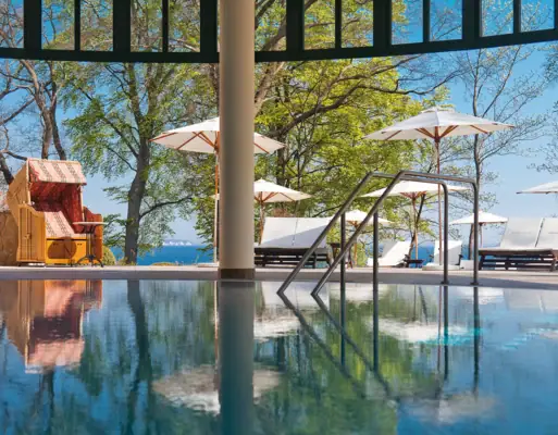 Een zwembad met ligstoelen en parasols.