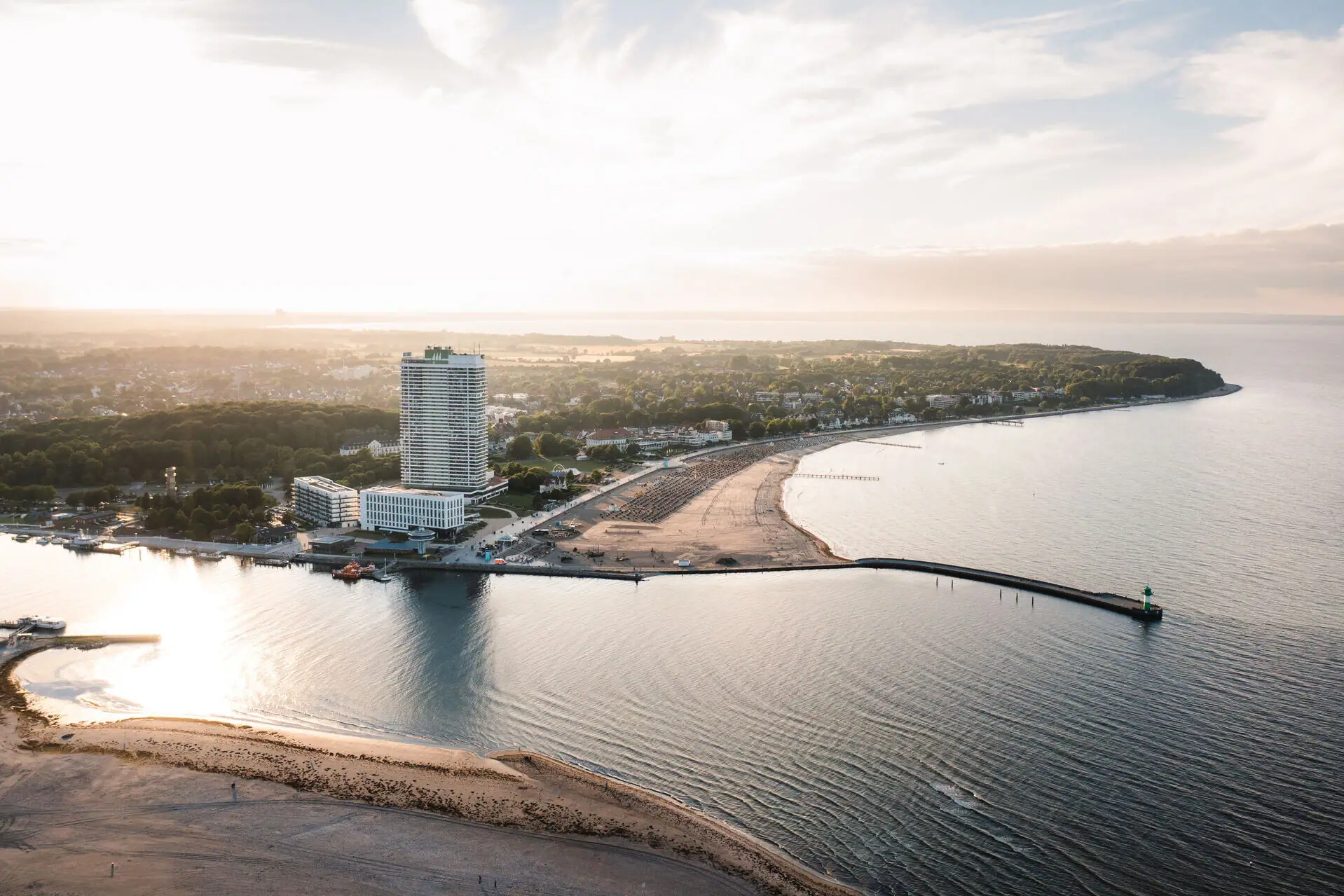 Een strand met water en een gebouw.