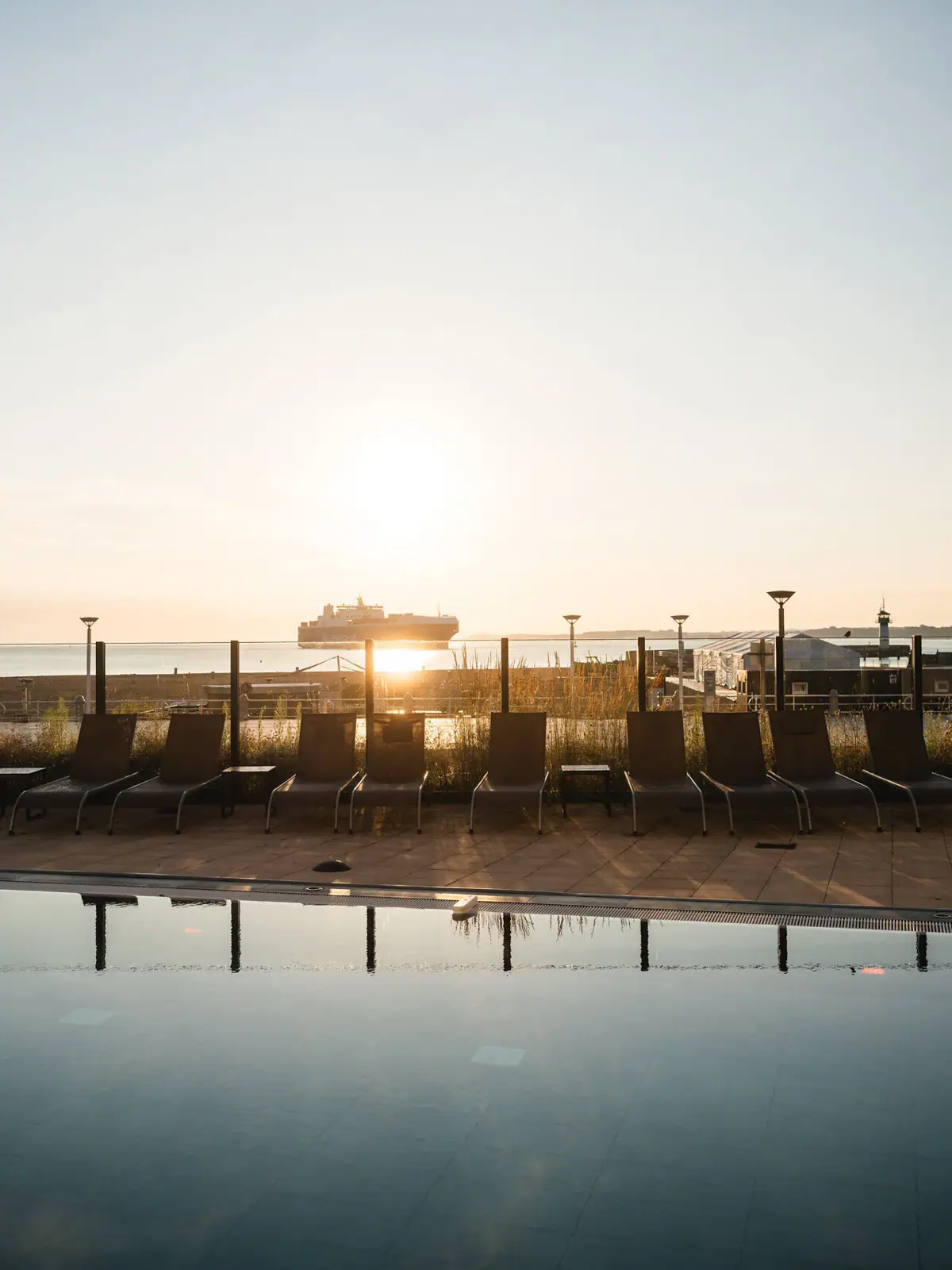 Buitenzwembad aja Travemünde Een rij stoelen bij het buitenzwembad.