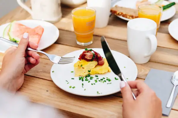 Roerei Eén persoon eet een maaltijd aan een tafel.