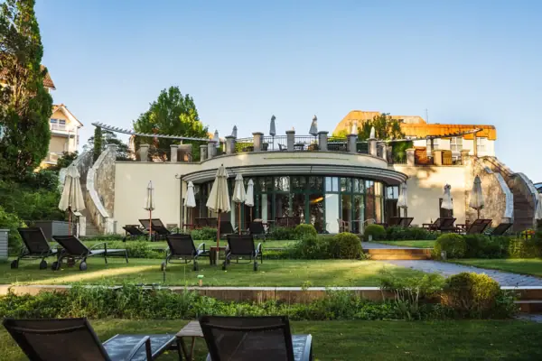 Gazon met stoelen en parasols voor een gebouw