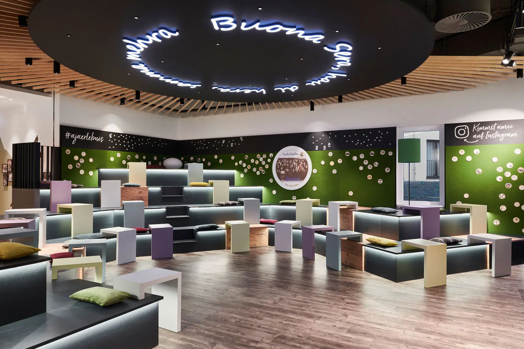 Een ruimte met veel kleurrijke banken en tafels.