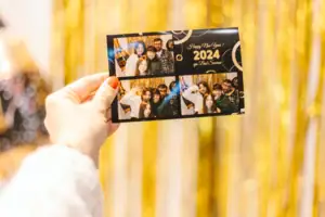 Fotohokje Eén hand houdt een kaart met een groep mensen vast.