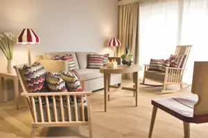 Woonkamer met bank en stoelen.