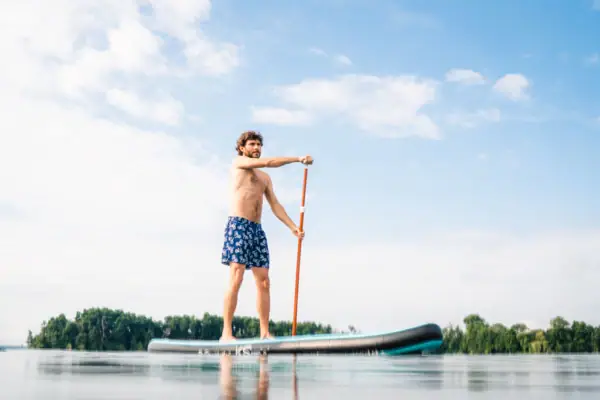 Ein Mann auf einem Stand-Up-Paddle-Board auf einem See.