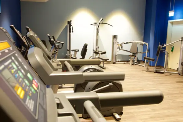 Een ruimte met fitnessapparaten.