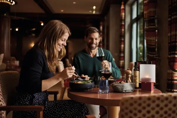 Een man en een vrouw eten aan een tafel.